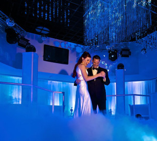 Bride & Groom dancing on a floor with low-lying fog simulating a cloud effect